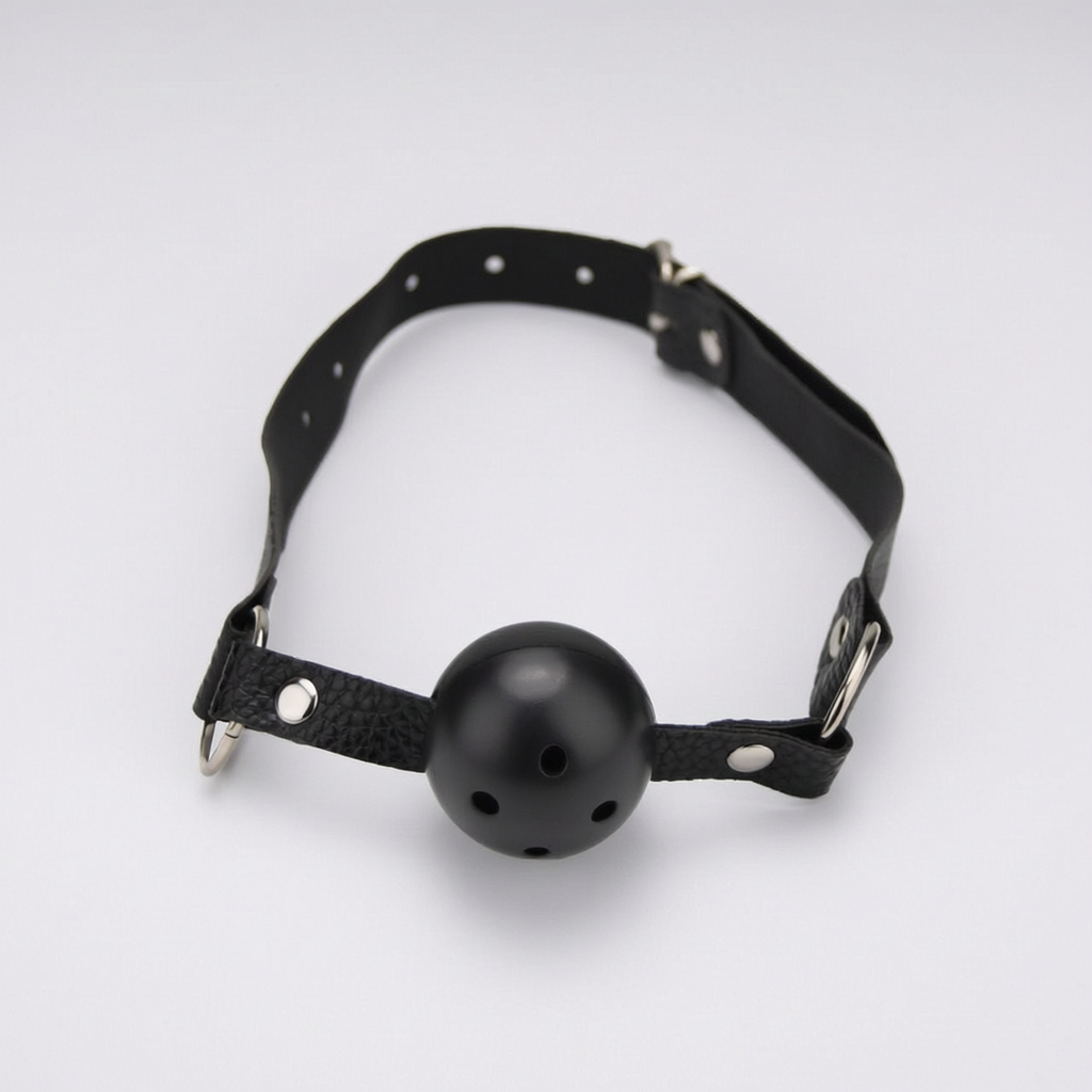 Black leather gag collar with a matte black silicone ball mouthpiece and silver metal hardware, photographed on a clean light gray background.