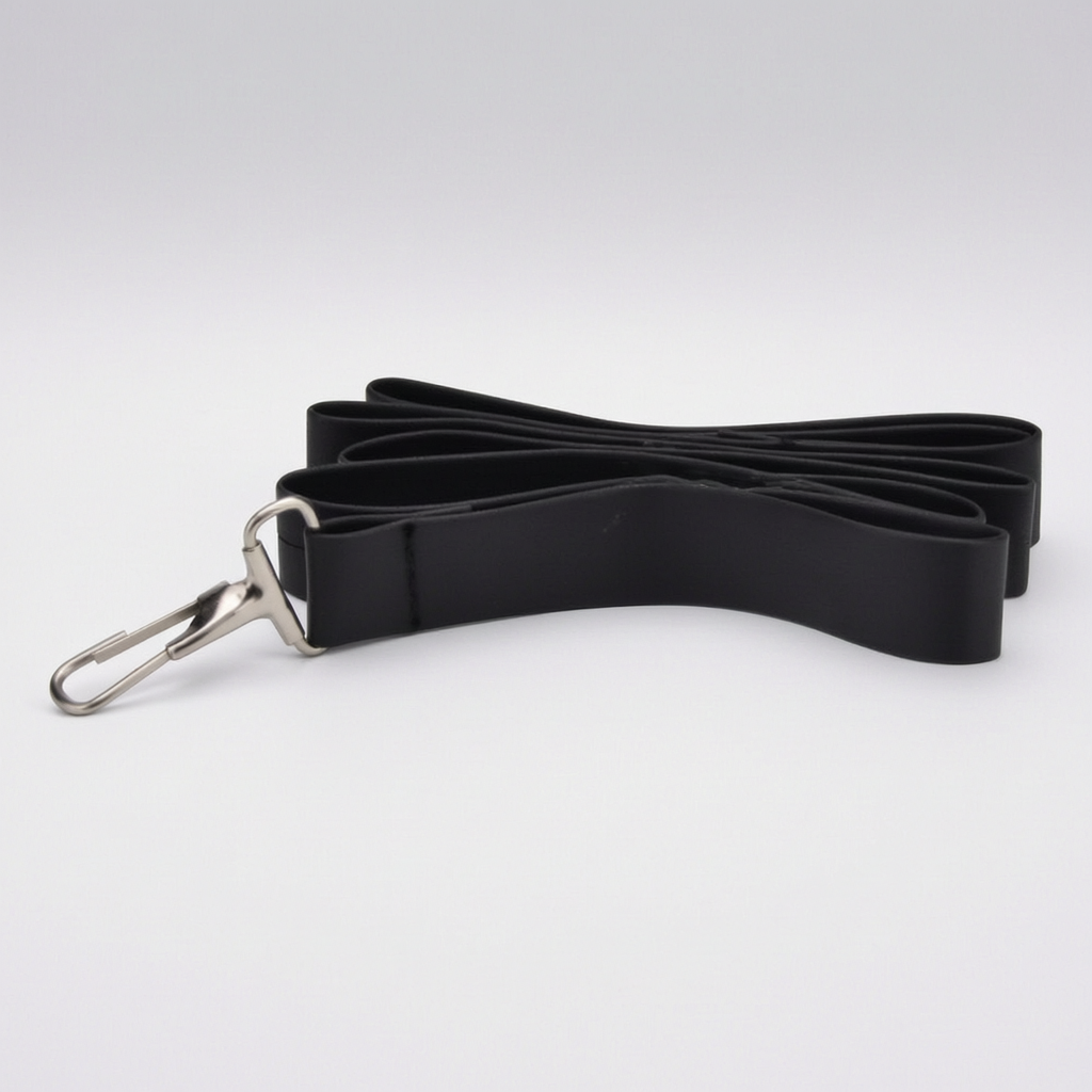 A black fabric strap - adults' play leash - with a silver metal swivel clasp, photographed on a clean light gray studio background. As part of an adult couples' bondage kit. 